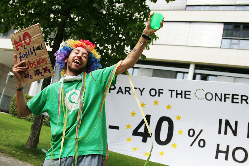 A young climate activist demands an end to fossil fuel subsidies during a spoof party to celebrate 40% carbon <br />emissions reduction targets outside the Bonn climate talks. Photo for Young Friends of the Earth Europe. <br />GERMANY, Bonn | 2011